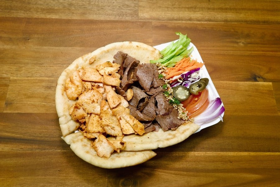 Grilled chicken and lamb doner on flatbread with salad